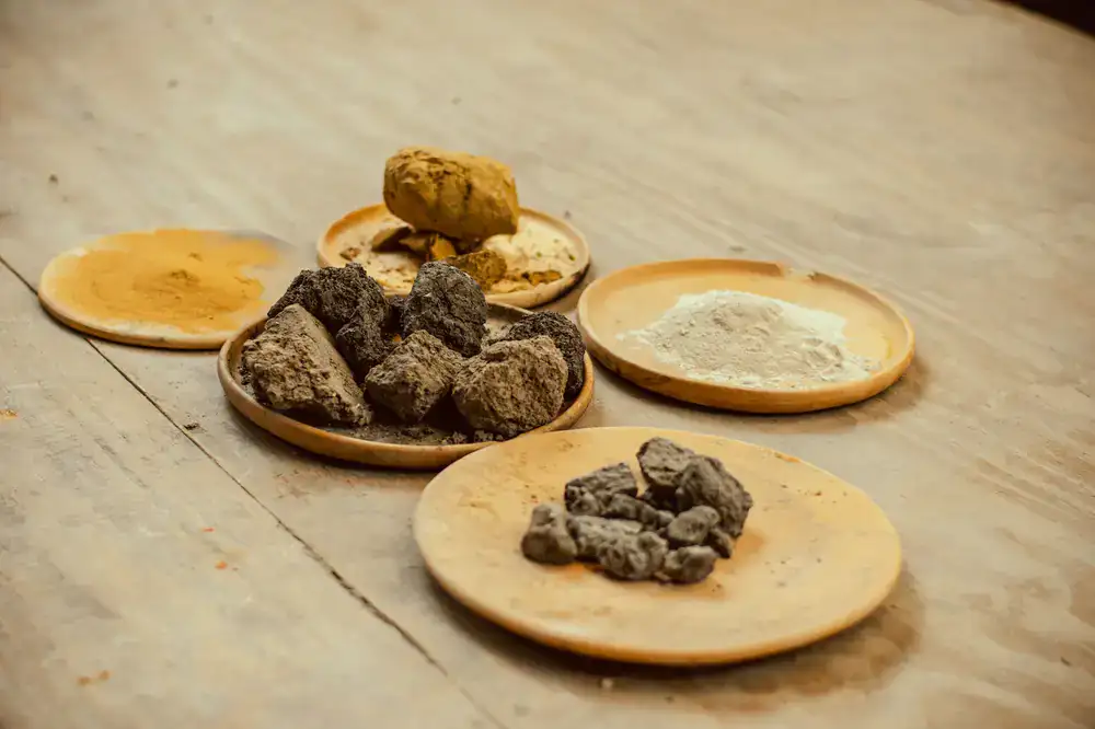 Bowls of raw dye materials like madder root and indigo powder
