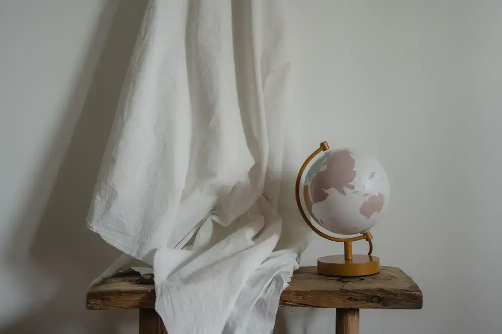 Large naturally dyed fabric draped over a studio worktable