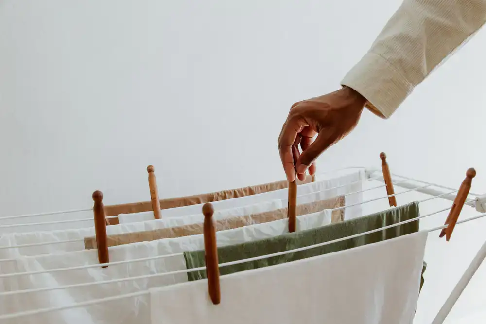 Hands washing natural linen fabrics in a tub
